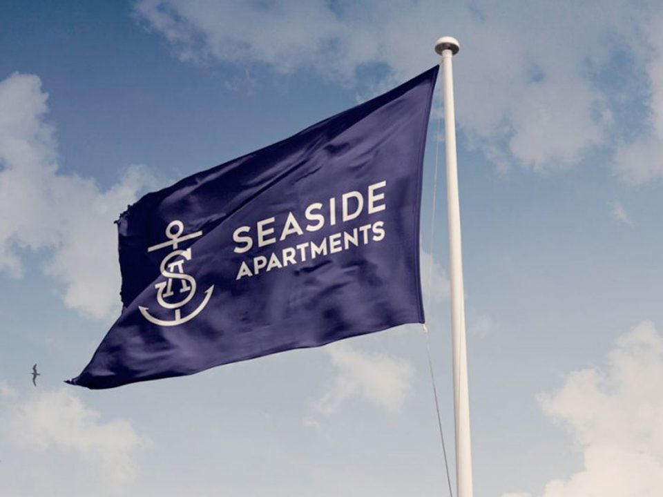 Seaside Apartments logo on flag